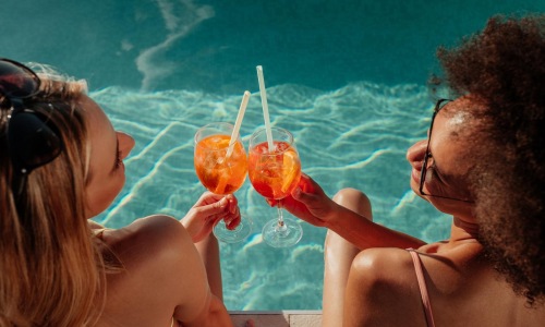 a man and woman drinking from glasses