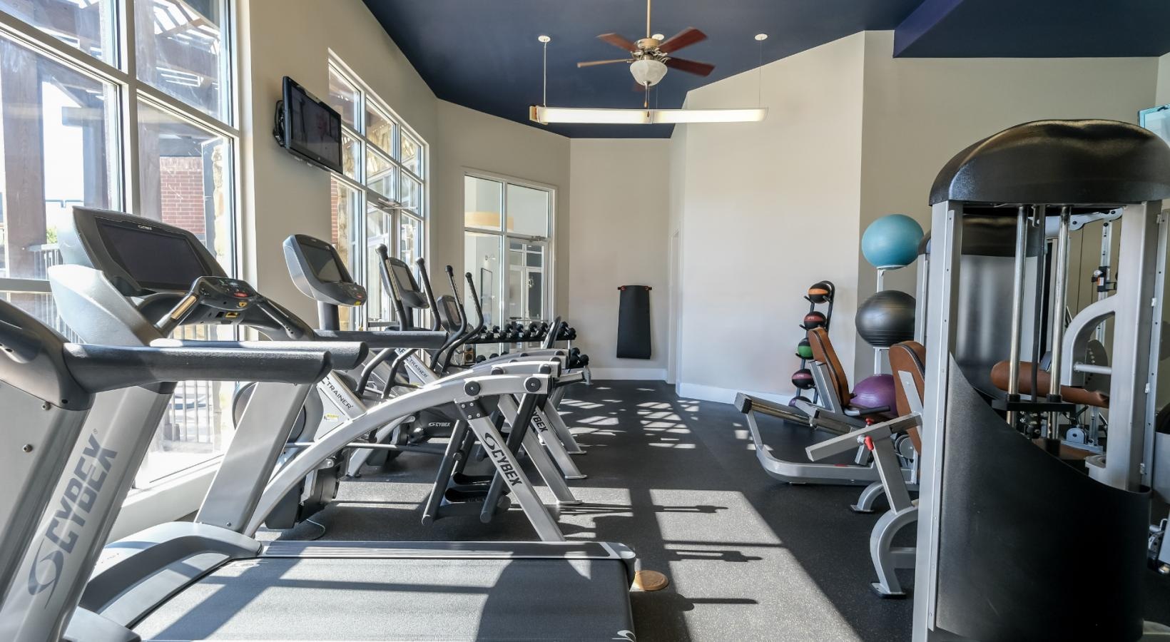 State-of-the-art amenities a gym with exercise equipment