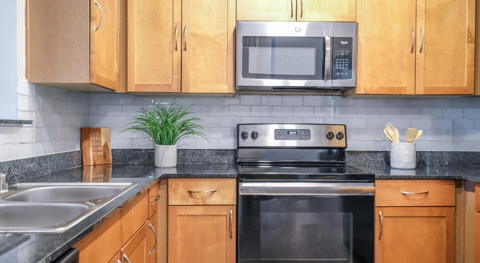 Spacious kitchens with thoughtful details a kitchen with black appliances