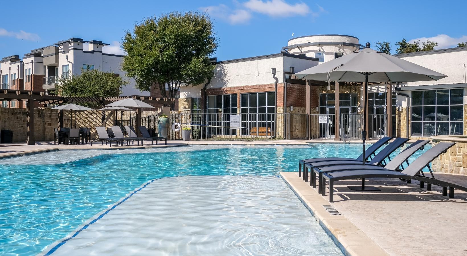 Resort-style swimming pool a swimming pool outside of a building
