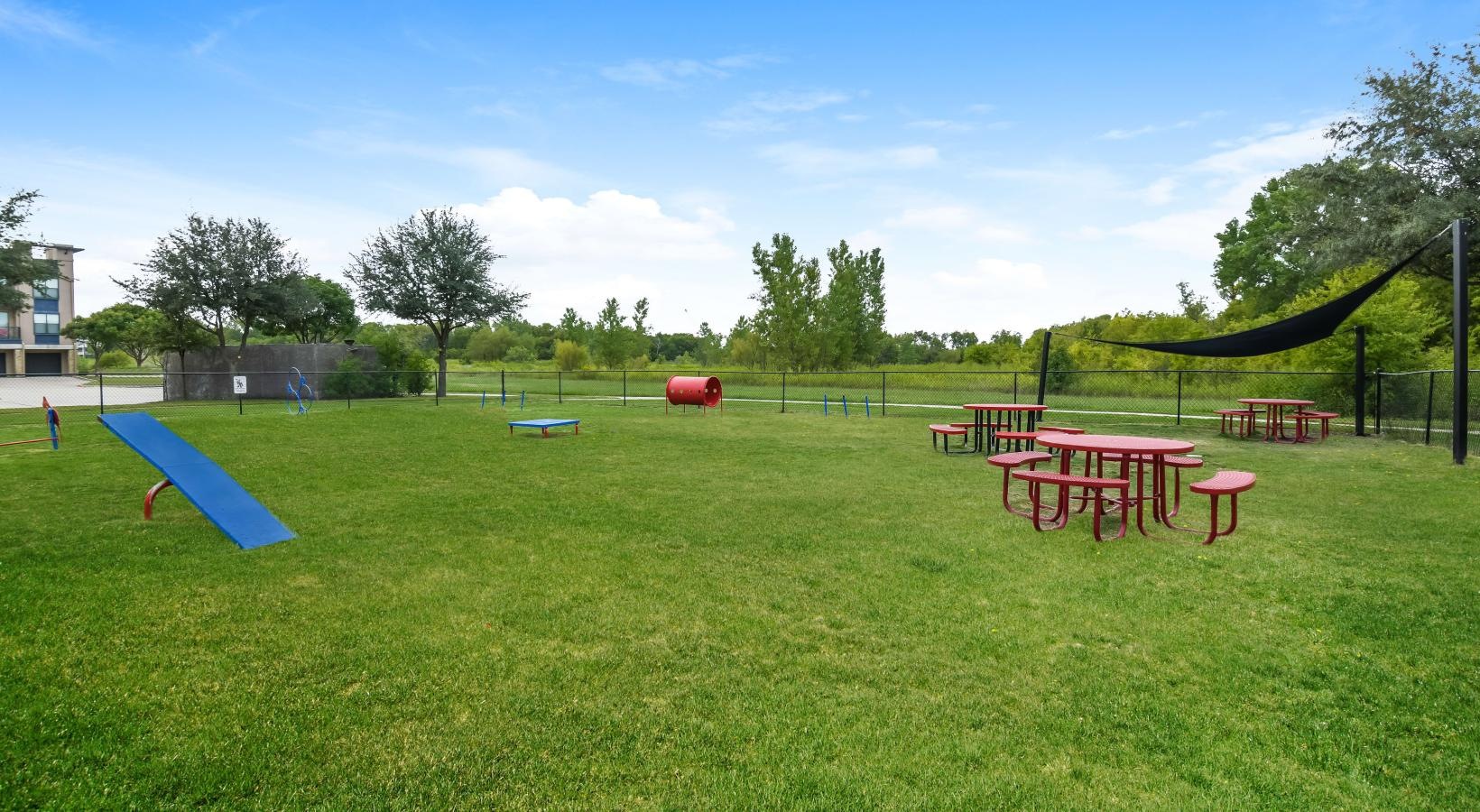 Settle into comfort at Soho Parkway a grassy area with a playground in the background