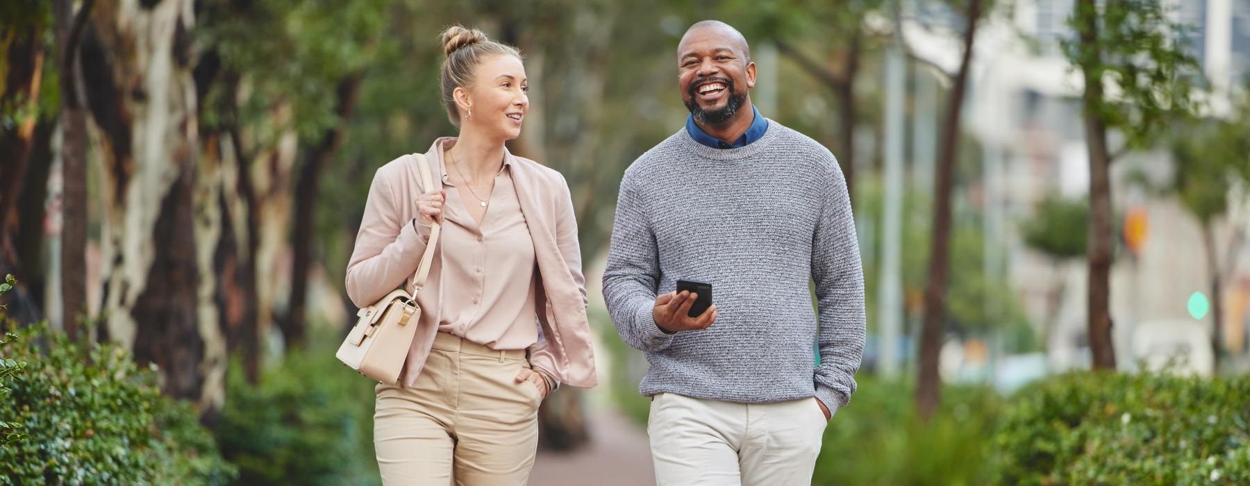 a man and a woman walking on a sidewalk