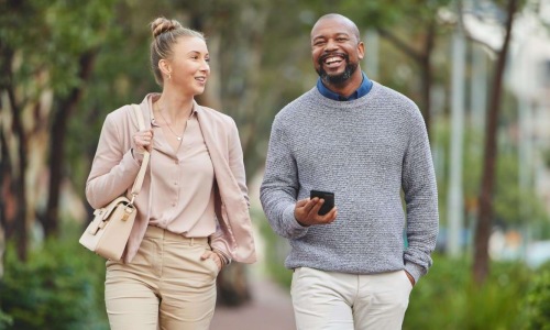 a man and a woman walking on a sidewalk