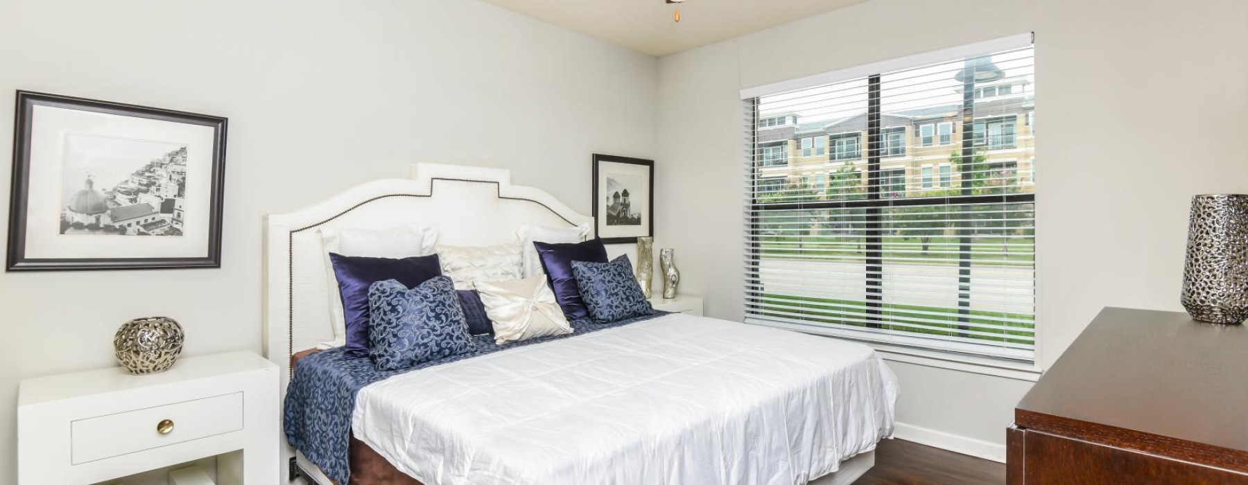 a bedroom with a bed and a fan