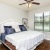 a bedroom with a bed and a fan